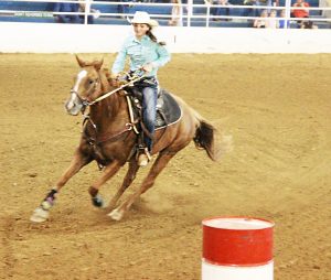 Taylor Sharp runs barrels during a rodeo competition at the Muhlenberg County Agricultural Center. Sharp also competes in pole bending and goat tying. 