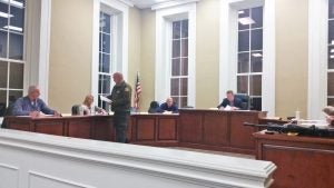 Kendra Peek/kendra.peek@amnews.com Garrard County Sheriff Tim Deputy hands magistrates a stack of papers citing the Kentucky Revised Statutes relating to allegations he claims were waged against him in a closed session.