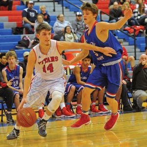 Matt Overing/matthew.overing@amnews.com Rhyan Lanham drives baseline during the first half of Friday's championship game against Lincoln County. He scored five points in the Titans' victory.