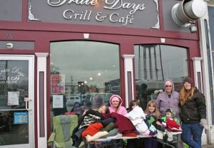 Kendra Peek/kendra.peek@amnews.com Katie Day, Cheyenne Day, Casey Gabbard, Nikki Gabbard, Amanda Gabbard, Xavier Diaz and Amber Day with Garrard County Girl Scout Troop 7418, hand out scarves, hats, and jackets outside Grate Days Grill and Café on Monday.