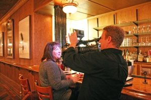 Kendra Peek/kendra.peek@amnews.com Michael Lattin, creator and producer of Secrets of Bluegrass Chefs, interviews Robin Moler at Cue on Main Tuesday night. Cue on Main and Nellie Burton's Steakhouse will be featured on an April episode of the show.