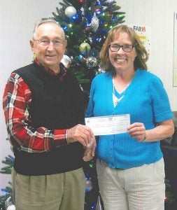 Holland-Farm: Rey Schaefer presents a check for $790 to Helen Overstreet, executive director of Holland-Farm, which is a day training program for adults with intellectual and developmental disabilities in our community.