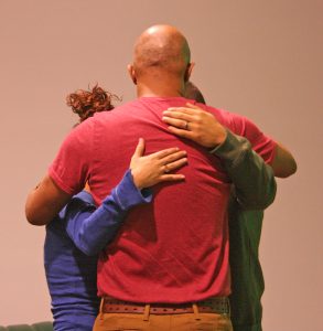 Kendra Peek/kendra.peek@amnews.com Pastor James Hunn, center, prays with Toni Ward, left, and her brother Rob Rodriguez, right, during the Hope Network meeting on Tuesday. Rodriguez was there to share his story of addiction and recovery, after graduating from a rehab center.