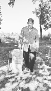 James Hunn of Danville stands by a military tombstone of his great-great-grandfather Jordan Wallace, a corporal in the Civil War. Wallace is buried in the Shelby City African American Cemetery.