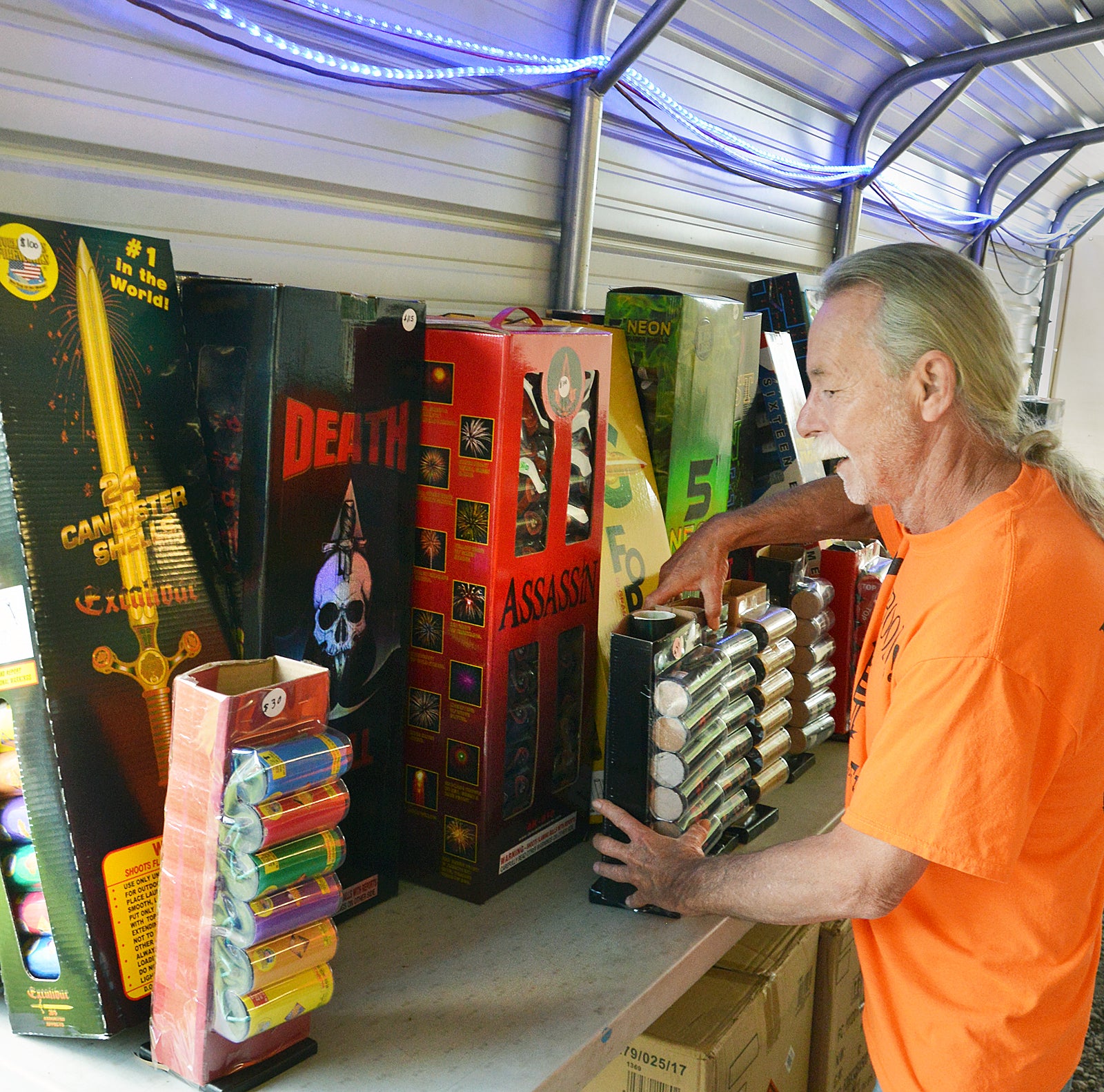 Ray Boone, owner of Fourth Street Fireworks and Little Sign Shoppe, keeps a supply of large artillary shells in his fireworks booth. He said safety protocol is very important when enjoying backyard fireworks. (Photo by Robin Hart)